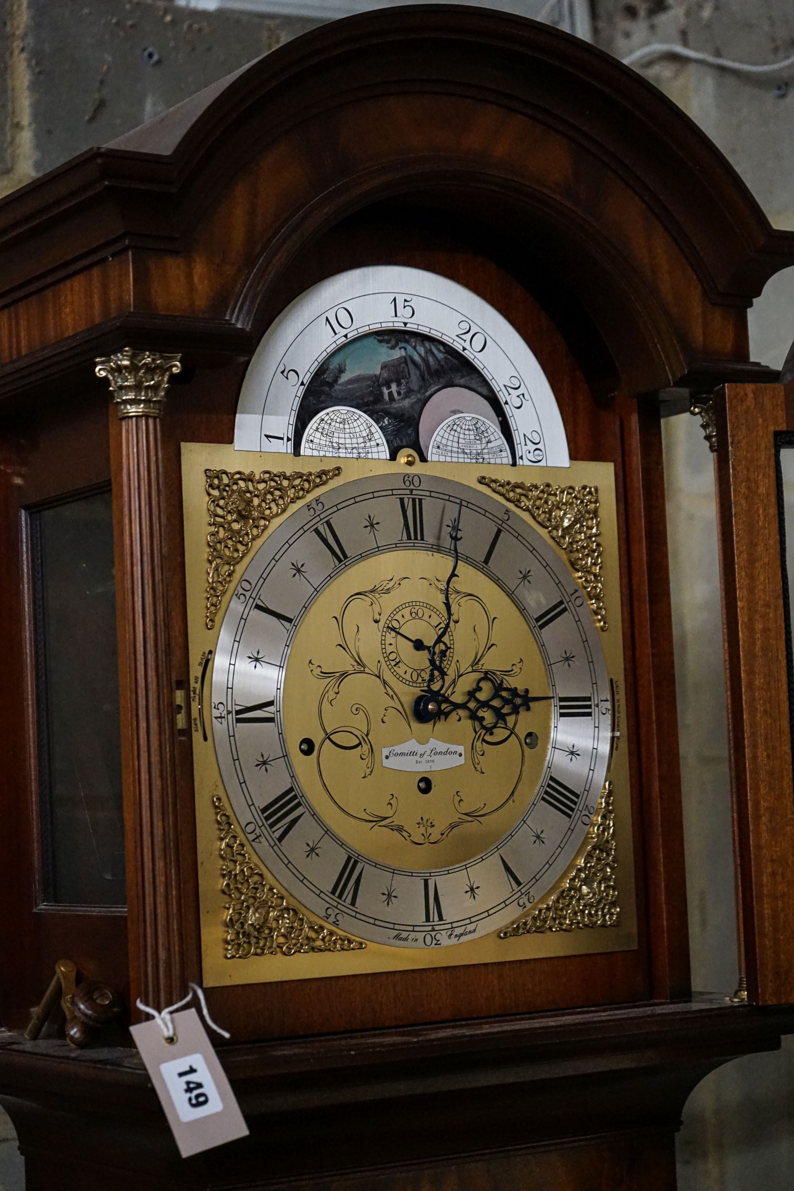 A modern mahogany longcase clock by Comitti London eight day, striking and chiming movement, brass dial with rocking ship automaton, the case with bulls-eye door, height 203cm